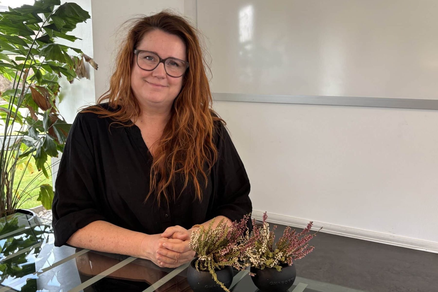 Kvinde med planter og blomsterarrangement